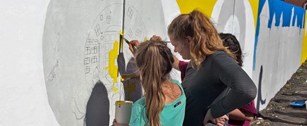 Elever fra Odense Friskole dekorerer letbanens byggehegn